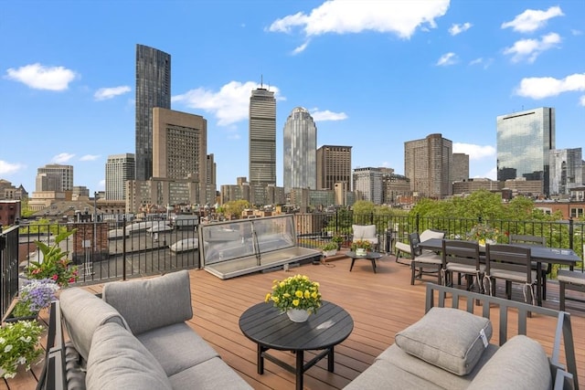 deck featuring a view of skyline and outdoor lounge area