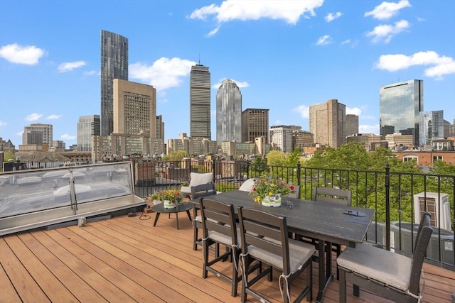 wooden deck featuring a skyline view