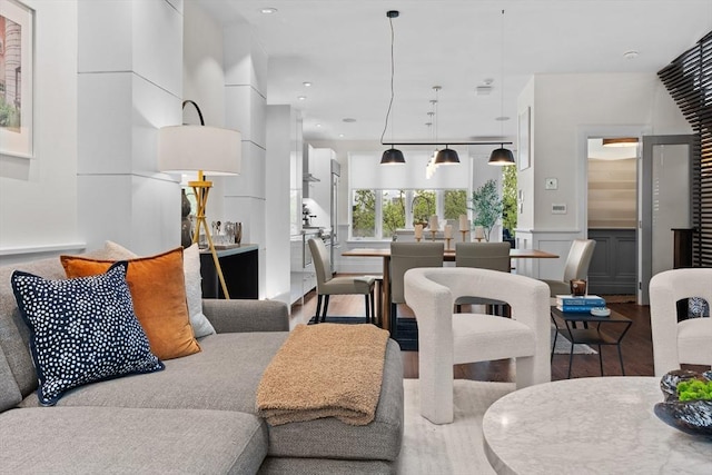 living area featuring wood finished floors, a wainscoted wall, a decorative wall, and recessed lighting