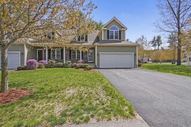 view of front of home with an attached garage, a front yard, and aphalt driveway