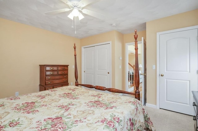 carpeted bedroom featuring a ceiling fan, baseboards, and a closet