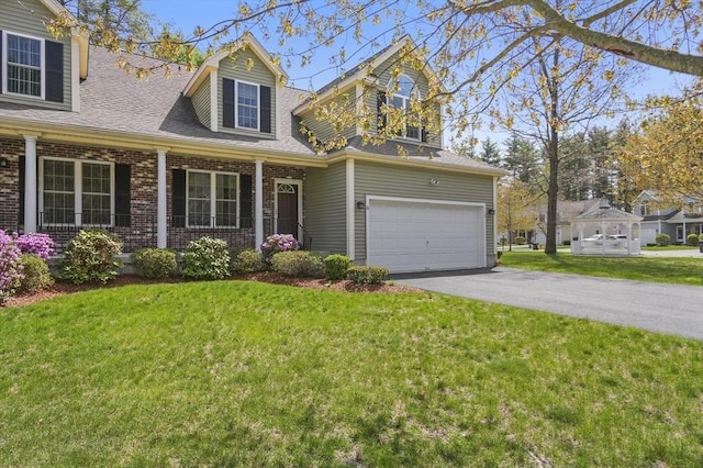 cape cod house with brick siding, an attached garage, a front lawn, and aphalt driveway