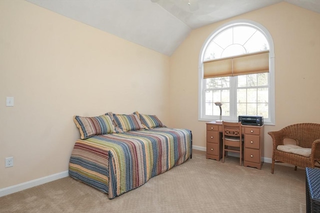 carpeted bedroom with baseboards and lofted ceiling