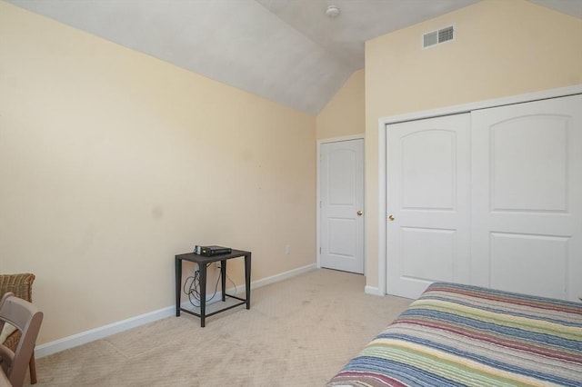 bedroom with light colored carpet, visible vents, vaulted ceiling, baseboards, and a closet