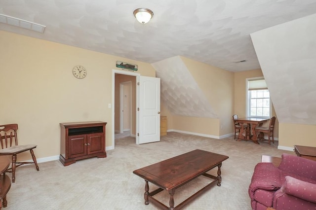 living room featuring visible vents, baseboards, and light carpet