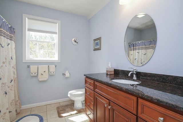 bathroom with baseboards, tile patterned floors, vanity, and toilet