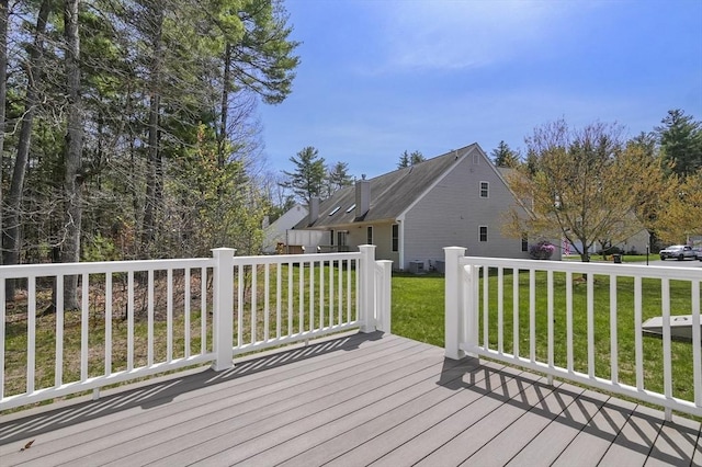 wooden deck featuring a yard