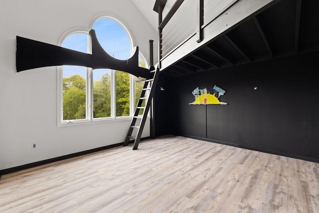 75 Narrows Rd, Freetown, MA 02702 - unfurnished room featuring plenty of natural light, wood finished floors, vaulted ceiling, and baseboards