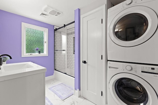 75 Narrows Rd, Freetown, MA 02702 - laundry area featuring stacked washer / drying machine, light marble finish flooring, and baseboards