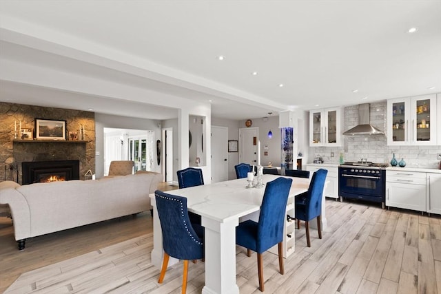 75 Narrows Rd, Freetown, MA 02702 - dining space featuring light wood finished floors, a fireplace, and recessed lighting