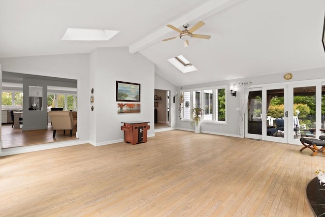 75 Narrows Rd, Freetown, MA 02702 - living area with a skylight, french doors, beam ceiling, light wood-type flooring, and high vaulted ceiling