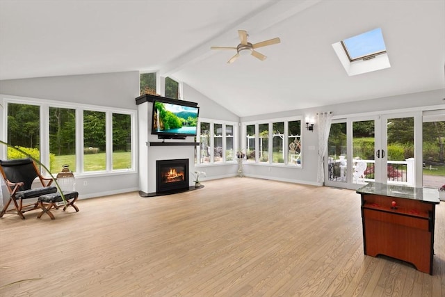 75 Narrows Rd, Freetown, MA 02702 - living room featuring ceiling fan, light wood-style flooring, french doors, a fireplace, and beamed ceiling
