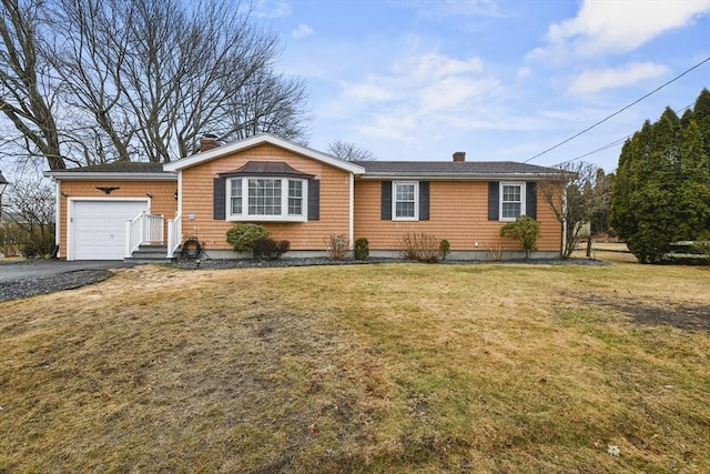 ranch-style home with aphalt driveway, a garage, a chimney, and a front lawn