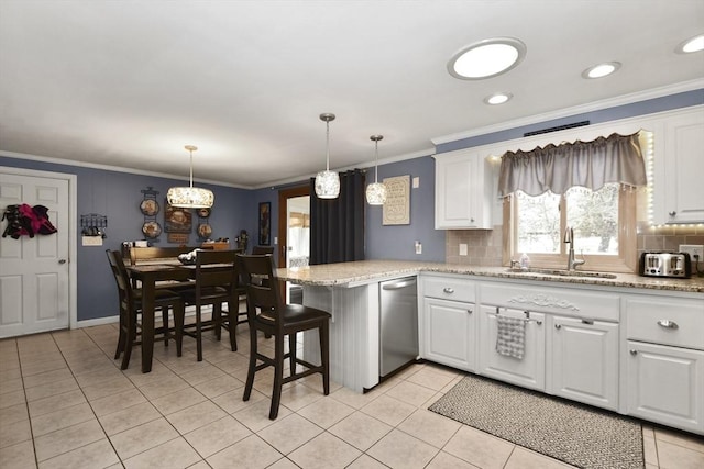 kitchen featuring dishwasher, a peninsula, crown molding, a sink, and light tile patterned flooring