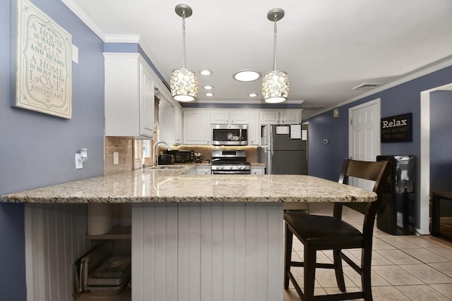 kitchen with light tile patterned floors, appliances with stainless steel finishes, a peninsula, crown molding, and a sink