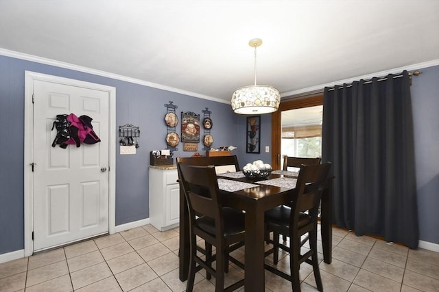 dining area with light tile patterned floors, baseboards, and crown molding