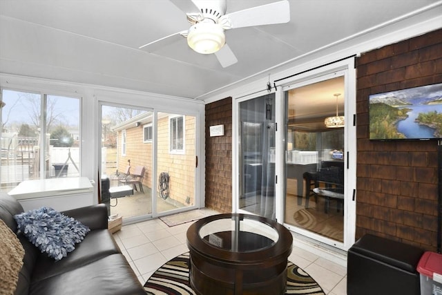 sunroom / solarium with a ceiling fan