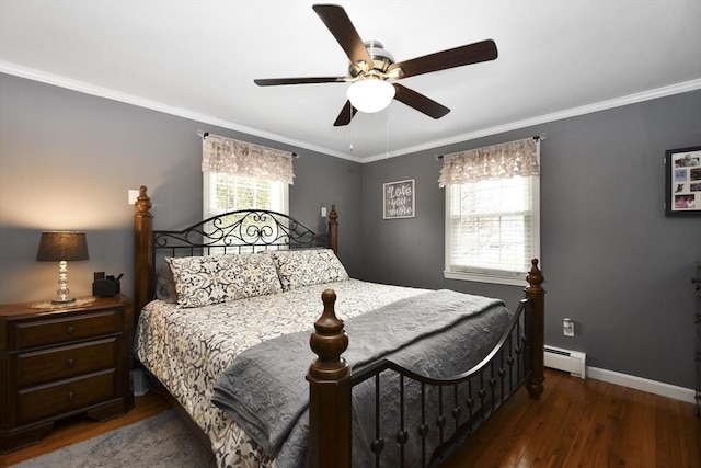 bedroom with baseboards, multiple windows, baseboard heating, and wood finished floors