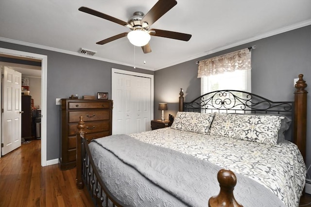 bedroom featuring ornamental molding, dark wood-style flooring, visible vents, and a closet