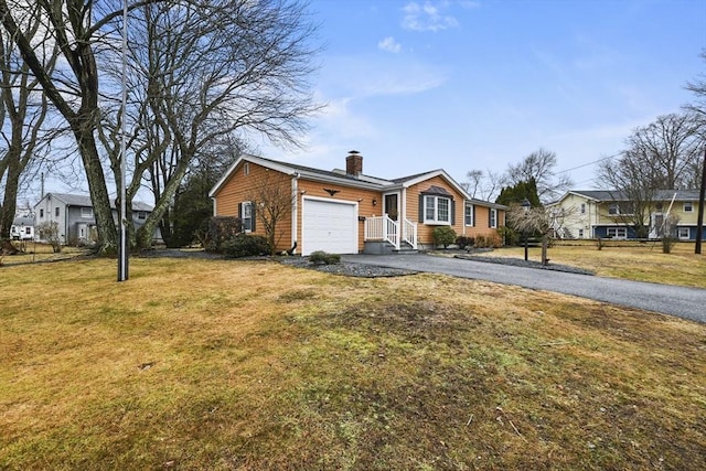 ranch-style house featuring a chimney, an attached garage, a residential view, driveway, and a front lawn