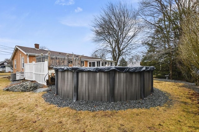 exterior space featuring a deck and a covered pool