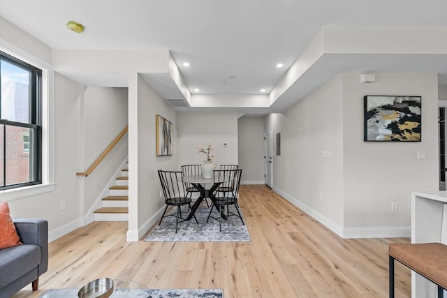 130 Cushing St Unit Ph1, Cambridge, MA 02138 - dining space with light wood finished floors, stairs, recessed lighting, and a tray ceiling