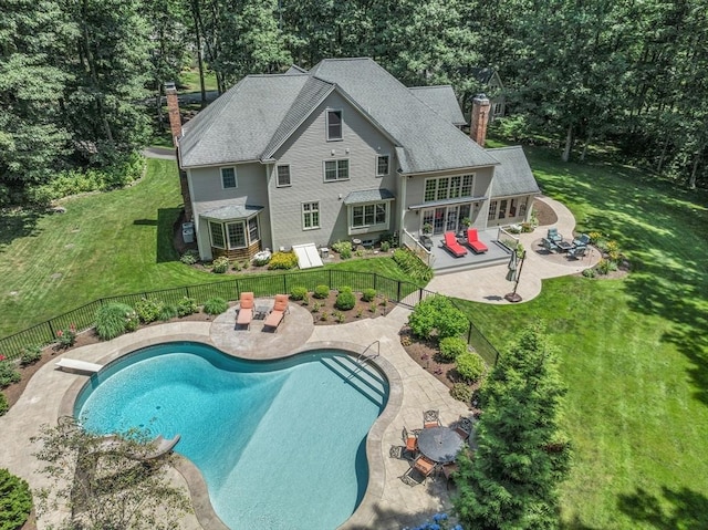 view of pool featuring outdoor dining area, a patio, a yard, and a fenced backyard