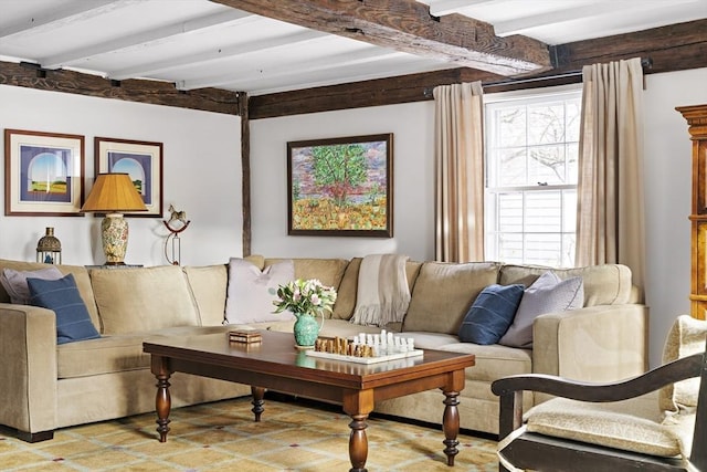 living room with a healthy amount of sunlight and beamed ceiling