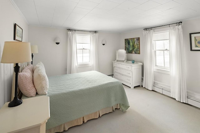 bedroom with ornamental molding and light carpet