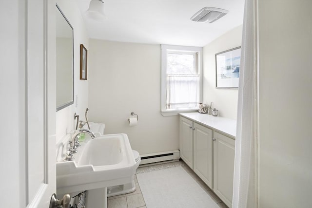 bathroom featuring tile patterned flooring and a baseboard heating unit