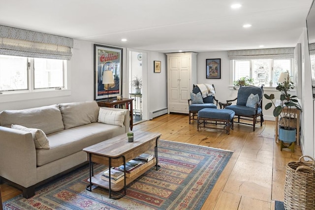 living room featuring hardwood / wood-style flooring and a baseboard heating unit