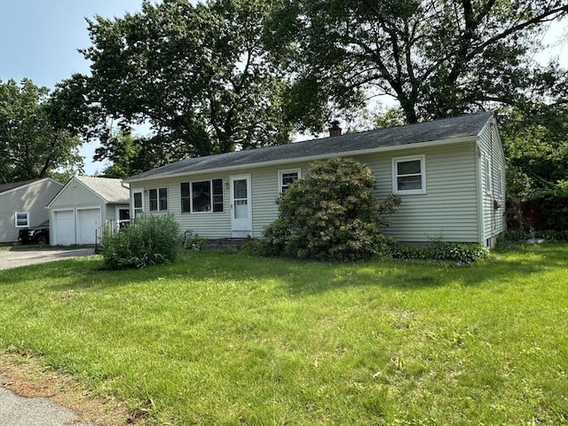 24 Arnold St, Ludlow, MA 01056 - view of front of property featuring a garage, a front yard, and a chimney