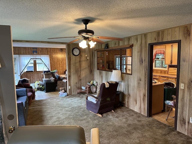 24 Arnold St, Ludlow, MA 01056 - carpeted living room with wood walls, a ceiling fan, and a textured ceiling