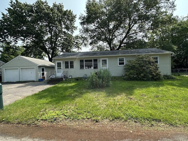 24 Arnold St, Ludlow, MA 01056 - view of front of home with an outbuilding, a garage, and a front lawn