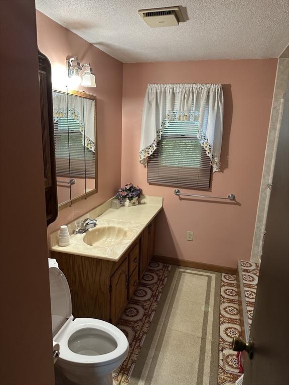 24 Arnold St, Ludlow, MA 01056 - bathroom featuring a textured ceiling and vanity