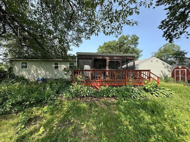 24 Arnold St, Ludlow, MA 01056 - rear view of house featuring a storage unit and a wooden deck