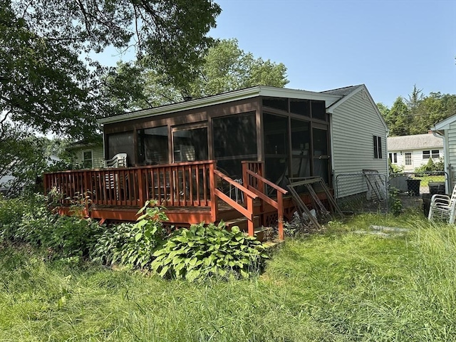 24 Arnold St, Ludlow, MA 01056 - rear view of house with a sunroom and a wooden deck