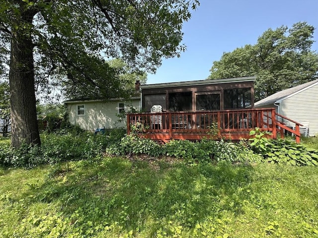 24 Arnold St, Ludlow, MA 01056 - rear view of house featuring a deck and a sunroom