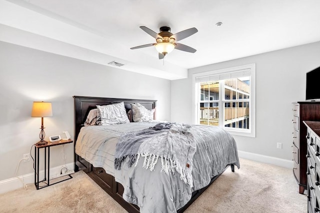 bedroom featuring baseboards, a ceiling fan, visible vents, and light colored carpet