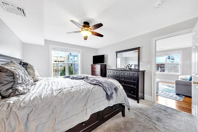 bedroom with ceiling fan, carpet flooring, baseboards, and visible vents