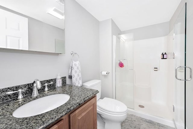 full bathroom with vanity, toilet, and a shower stall