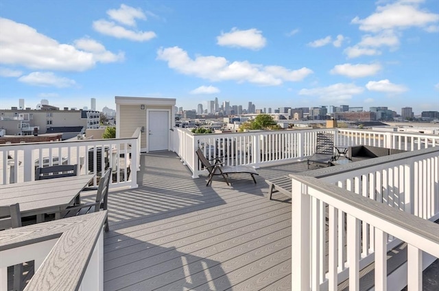 wooden terrace featuring a view of city