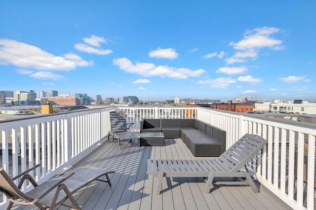 wooden terrace with outdoor lounge area and a view of city