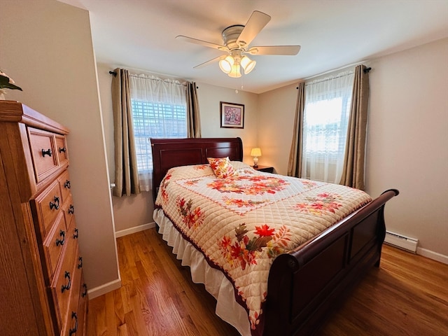 bedroom featuring a baseboard radiator, dark hardwood / wood-style flooring, and ceiling fan