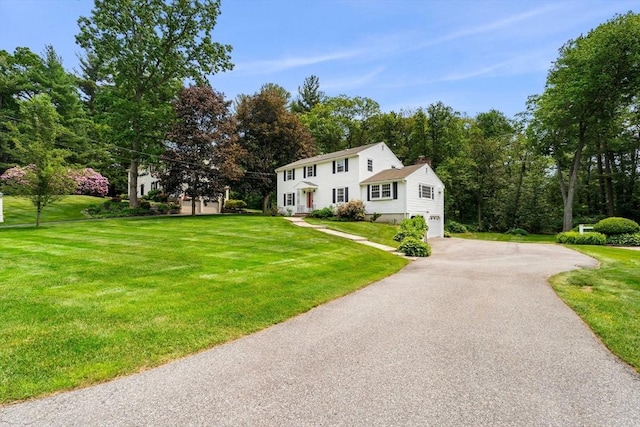 6 Lancaster Pl, Andover, MA 01810 - colonial house featuring a garage, asphalt driveway, a front lawn, and a chimney