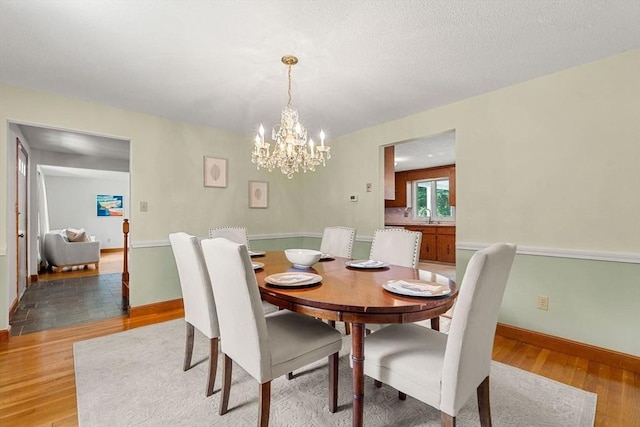 6 Lancaster Pl, Andover, MA 01810 - dining area featuring light wood-style floors, a chandelier, and baseboards