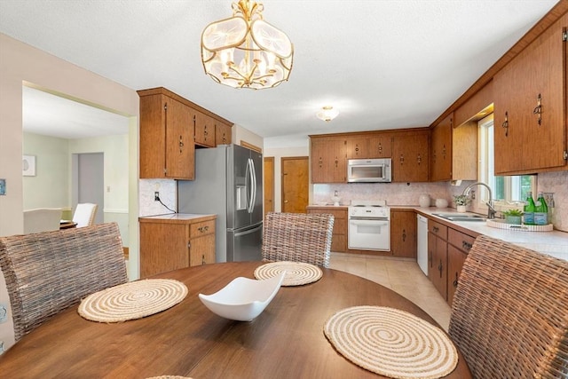 6 Lancaster Pl, Andover, MA 01810 - kitchen with appliances with stainless steel finishes, a sink, backsplash, and a chandelier