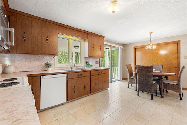 6 Lancaster Pl, Andover, MA 01810 - kitchen featuring dishwasher, a sink, tasteful backsplash, light countertops, and plenty of natural light