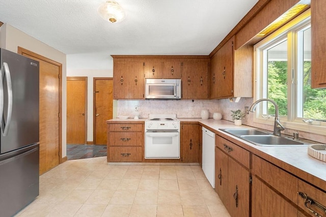 6 Lancaster Pl, Andover, MA 01810 - kitchen with appliances with stainless steel finishes, a sink, tasteful backsplash, and light countertops