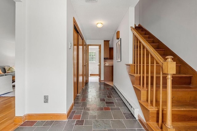 6 Lancaster Pl, Andover, MA 01810 - hall featuring baseboard heating, baseboards, stairs, and stone tile flooring